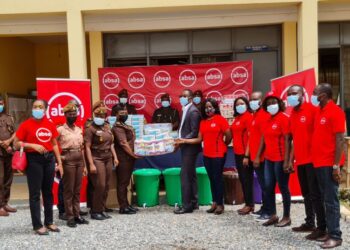 Absa Bank employees presenting the items to officials of the Senior Correctional Centre