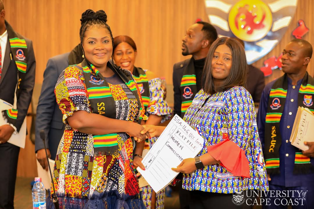 Mr Christopher Aggrey (R), the new Chairman of SAA-UCC, receiving a document from the immediate past President of SAA-UCC, Mr Sandy Kumi-Sinatra (L).