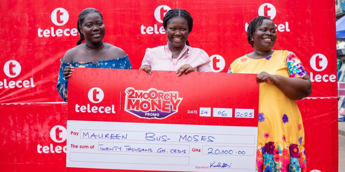Maureen Bus-Moses (middle), a 2Moorch Money promo weekly prize winner, receives the cheque of GH₵20,000 with her mother and sister at the Takoradi Market Circle