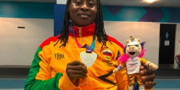 Zinabu Issah showing off her medal