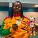 Zinabu Issah showing off her medal