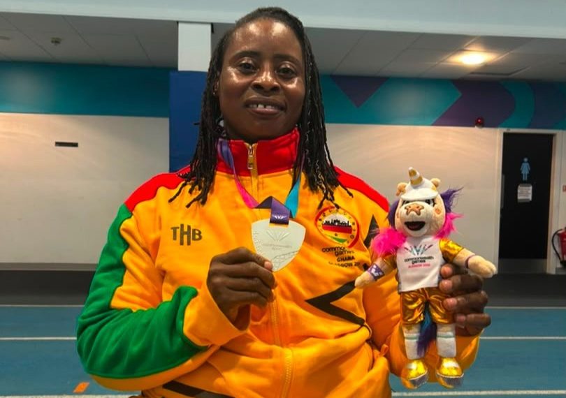 Zinabu Issah showing off her medal
